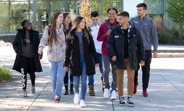 Students walking together in a group on the quad